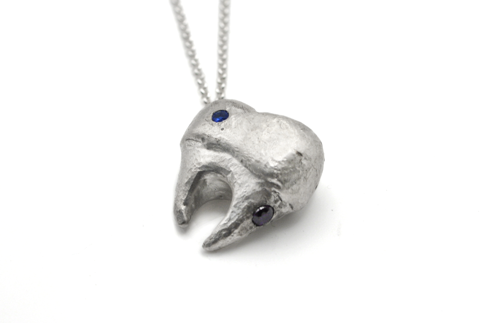 Hand-carved sterling silver TOOTH & TALES pendant. Perfect for those who cherish the tales and experiences of adulthood.