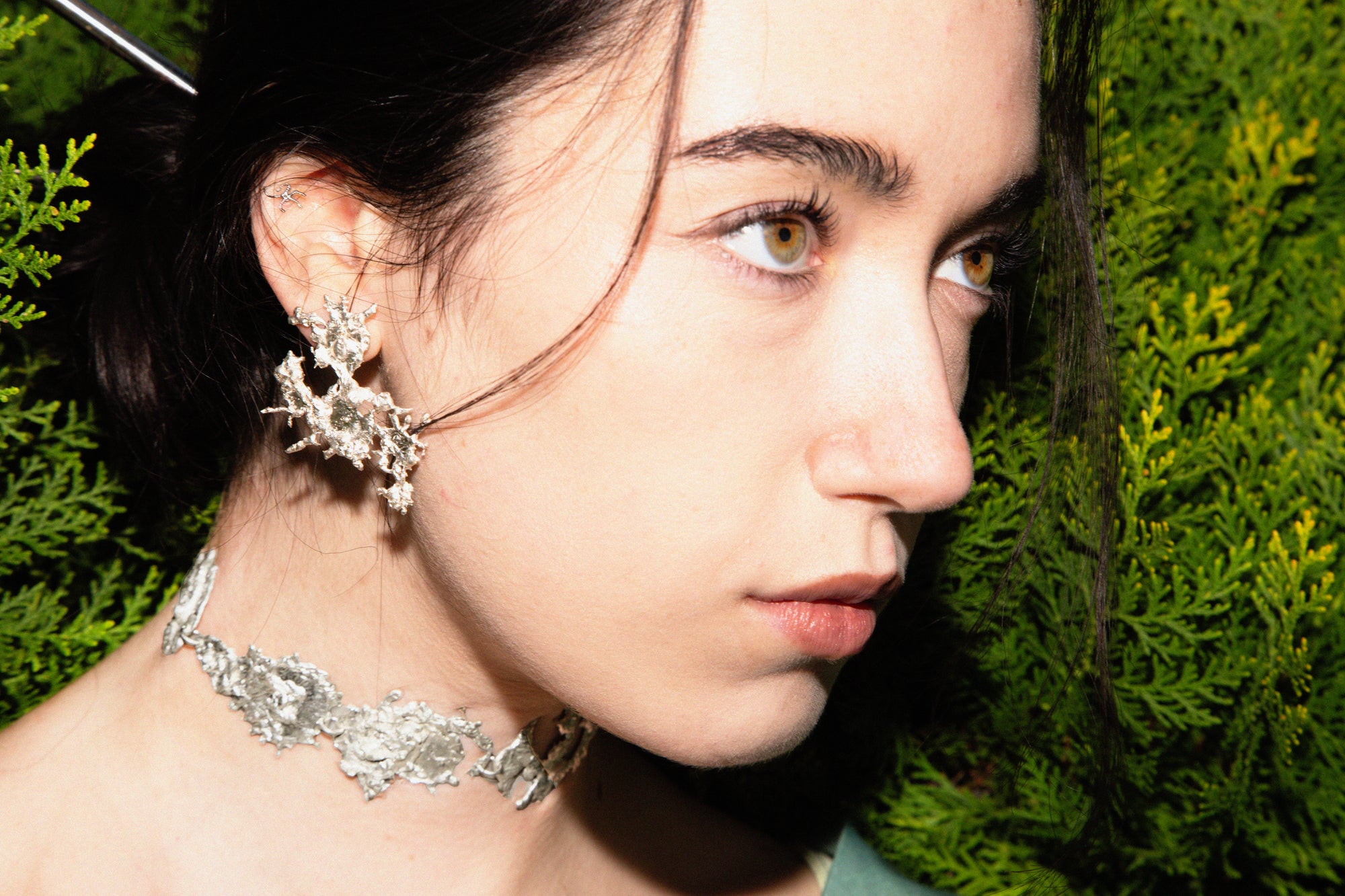 NEXUS earrings worn, displaying unique styling