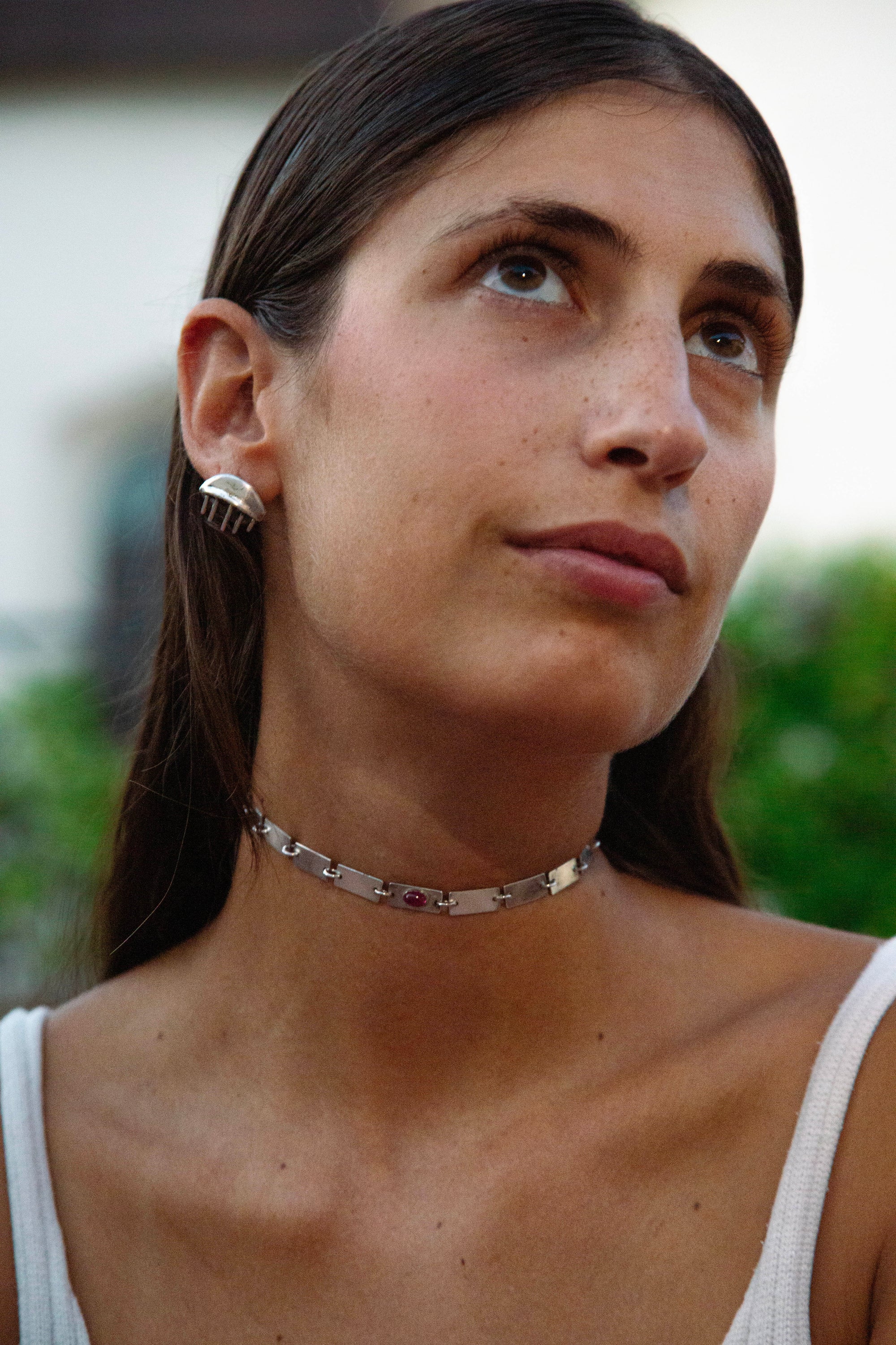 EYES WIDE SHUT earrings worn, displaying allure and enigmatic styling