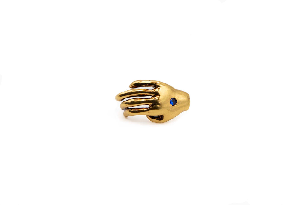 ECHO hand-carved 24K gold-plated brass earrings featuring a hand and a blue zircon
