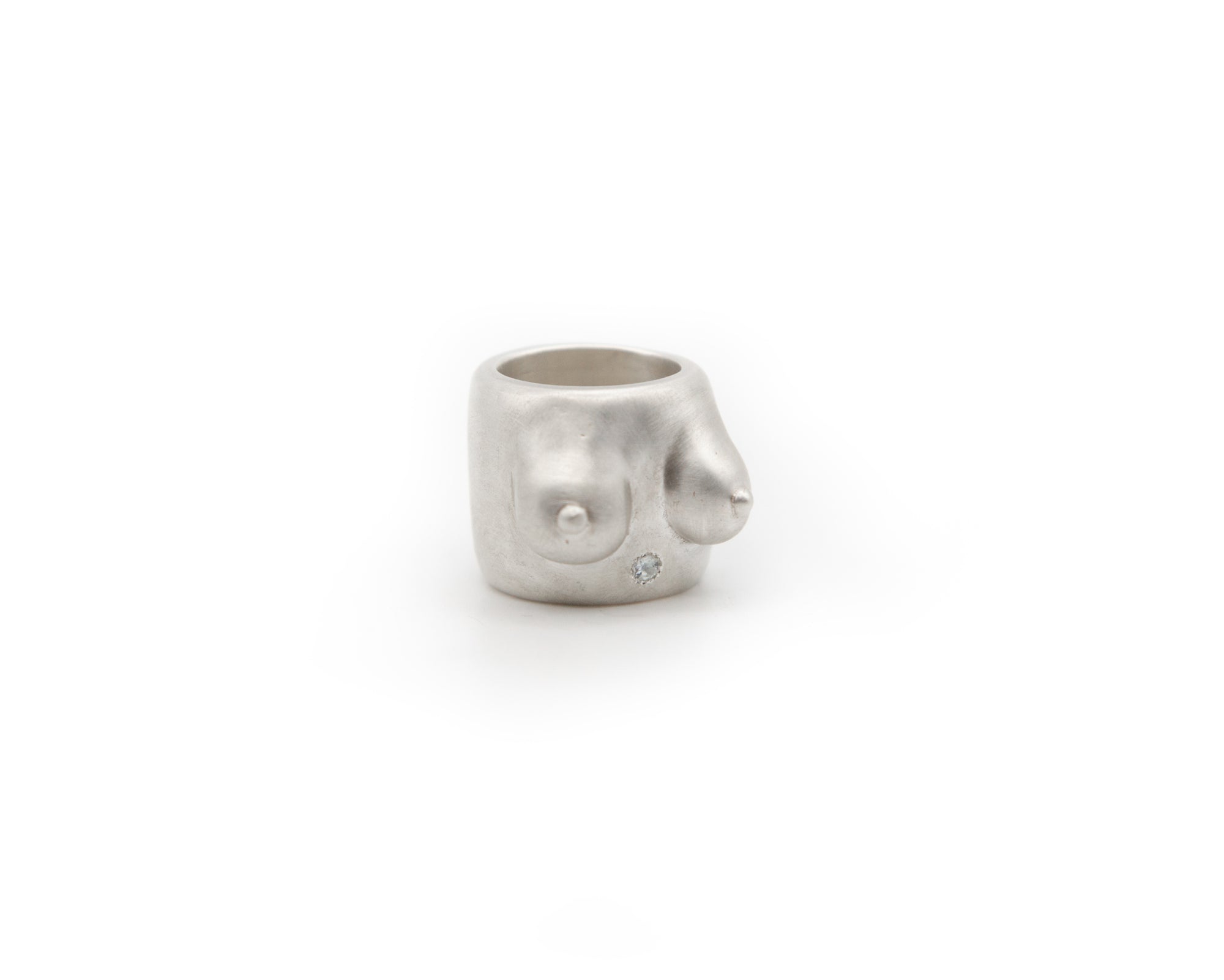 handmade piece that celebrates the human form. 925 sterling silver ring featuring a shiny blue topaz.