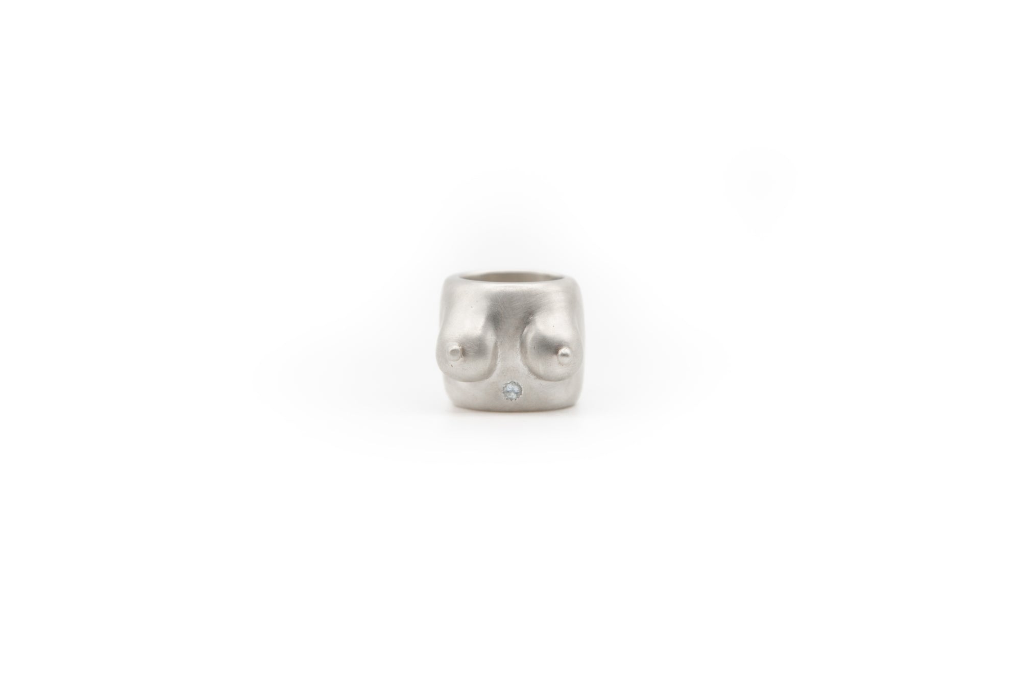 handmade piece that celebrates the human form. 925 sterling silver ring featuring a shiny blue topaz.