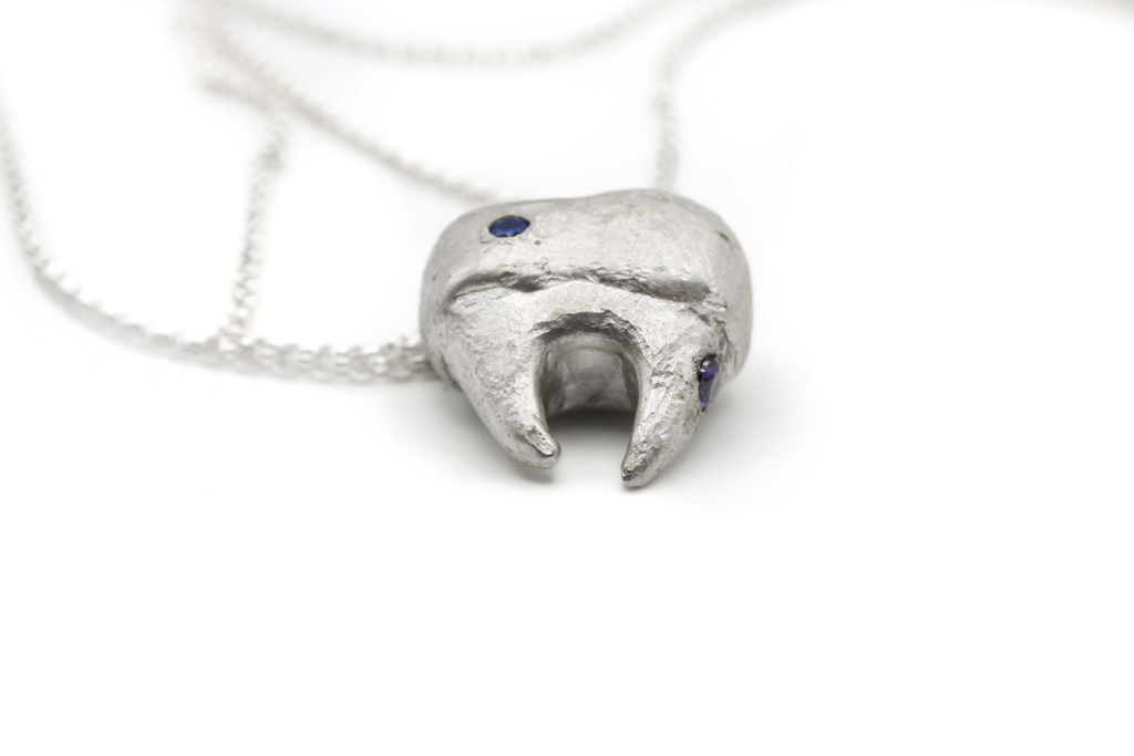Hand-carved sterling silver TOOTH & TALES pendant. Perfect for those who cherish the tales and experiences of adulthood.