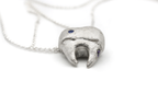 Hand-carved sterling silver TOOTH & TALES pendant. Perfect for those who cherish the tales and experiences of adulthood.