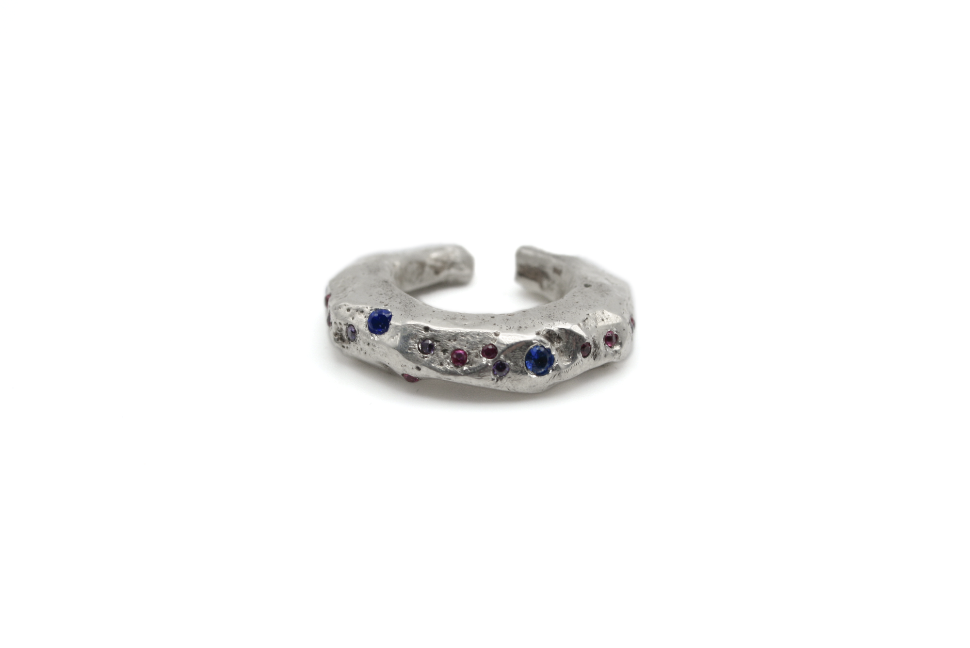 Close-up of VAN GOGH ear cuff showing hand-carved swirling details and hand-set rainbow zircons